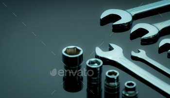 Set of chrome wrenches or spanners and hexagon socket on dark table in workshop. Chrome vanadium