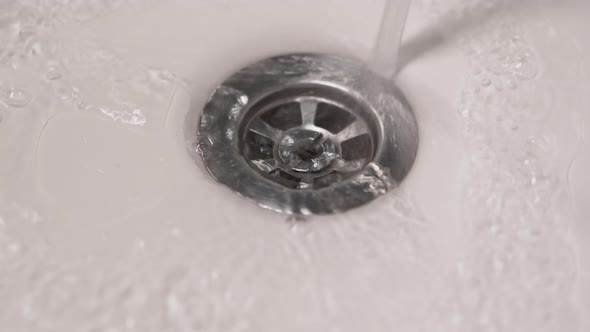 Streaming Water in White Sink