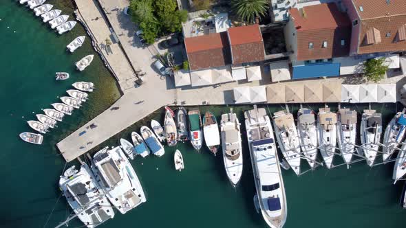 Aerial video from iconic traditional fishing village and bay of Fiskardo with beautiful houses and I