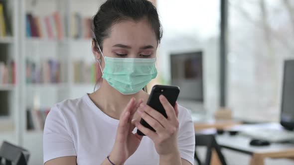 Portrait of Asian Woman with Face Mask Using Smartphone