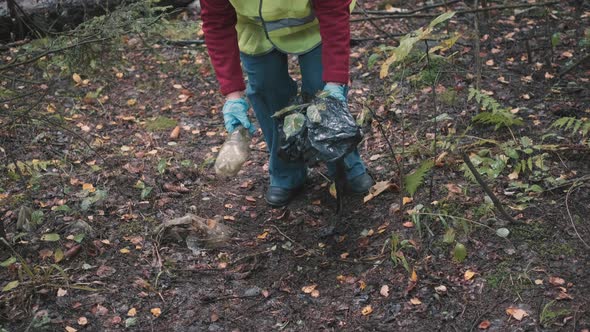 Ecologist Woman in Workwear and Helmet Clean Plastic Garbage in Forest