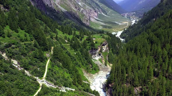 Drone flight from the direction of Zinal glacier through the valley through towards the village of Z