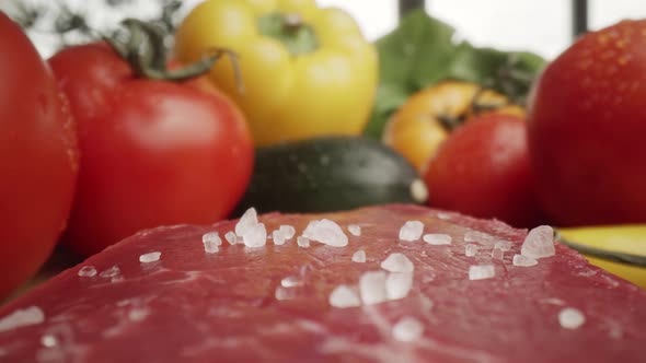 Zoom out macro video of sea salt on raw steak. Shot with RED helium camera in 8K