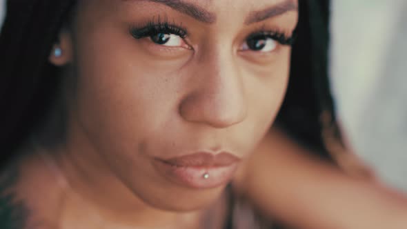 young south american woman stares thoughtfully at camera - close up