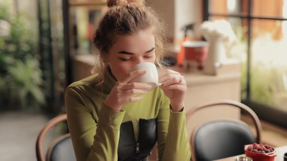Young Woman Sniff an Aroma of Tea in a Cafe