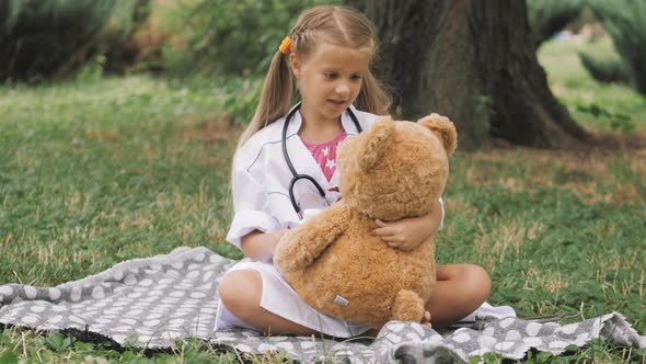 Playing hospital game pretend doctor in the park. Child with a Medical pills. Doctor and patient.