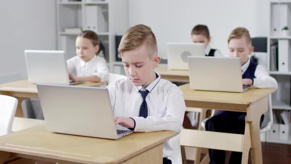 Primary School Pupils Using Laptops in Class