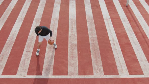 Man dribbling a basketball while running