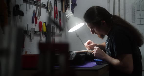 Luthier Heats Frets on Guitar By Soldering Iron Before Refretting Preparations for Frets Replacement