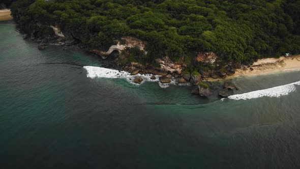 Beautiful Bingin beach with exotic cliffs houses and hotel located in Bali, Indonesia. This drone fo