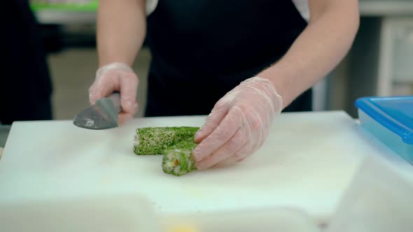 Cook Cuts Japanese Rolls with Dill.