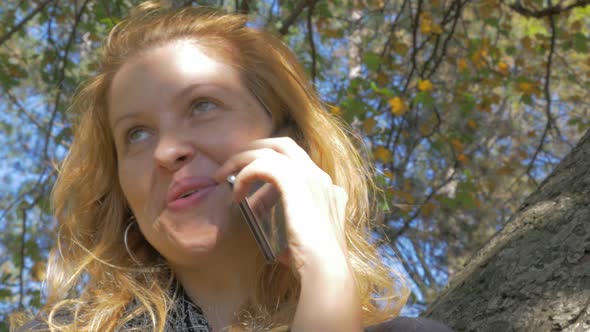 Blonde Causcasian girl alking on phone 4K 2160p UHD video - Modern girl outdoor phone using 4K 3840X
