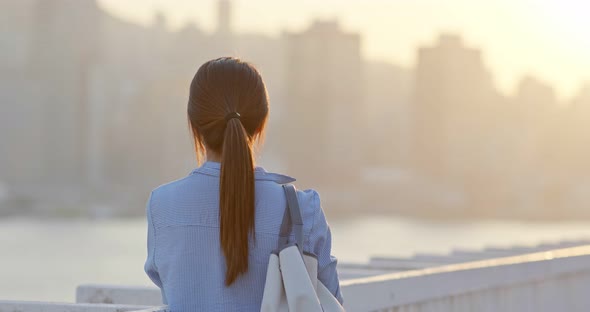 Woman look at the city in the evening