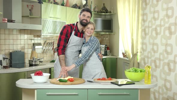 Couple Near Cooking Table Smiling