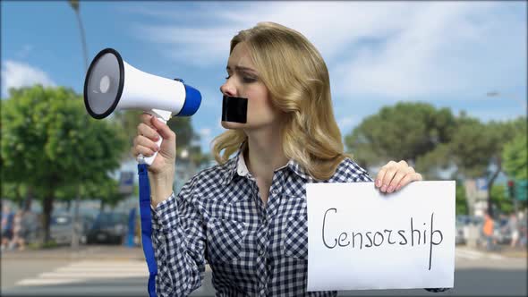 Portrait of Female Protester Trying to Speak in Megaphone