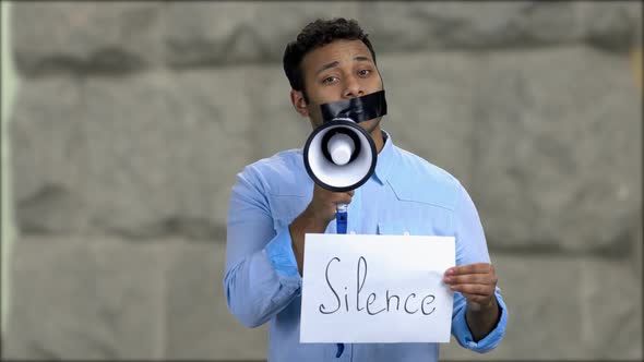 Young Male Protester with Tape Over Mouth