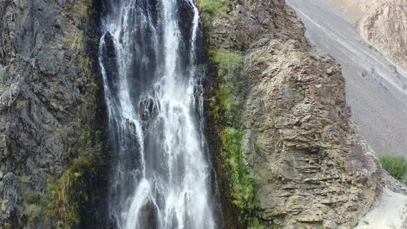 aerial drone circling left tracking an artificial waterfall called Manthokha Waterfall in the mounta