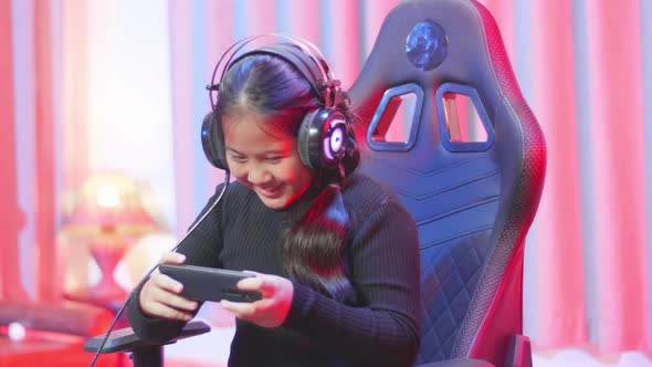 Cute Girl Using Her Smartphone Playing Online Games  alt