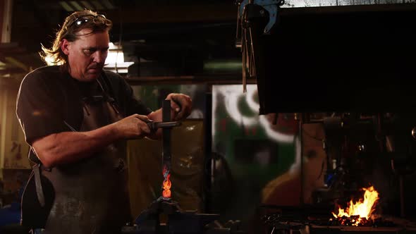 Blacksmith working at workshop