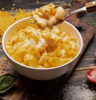 Wooden table with a bowl of mac and cheese