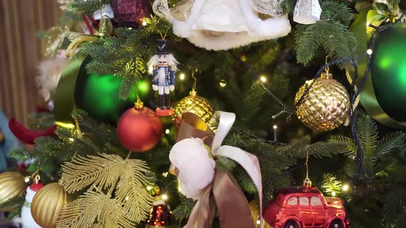 Part of the Christmas Tree with Different Toys and an Electric Garland