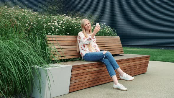 Woman Making Video Call on Green Roof.