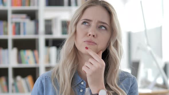 Young Woman Thinking at Work