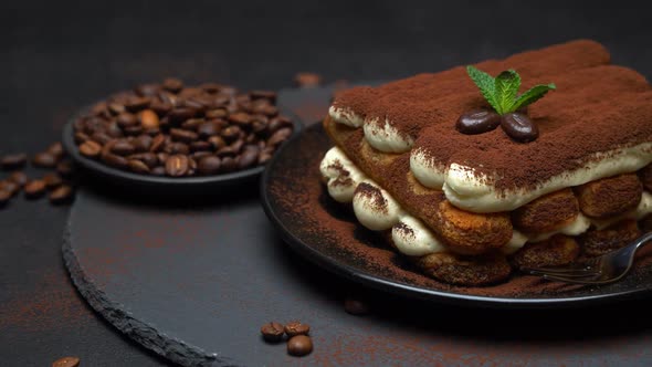 Classic Tiramisu Dessert on Ceramic Plate on Concrete Background