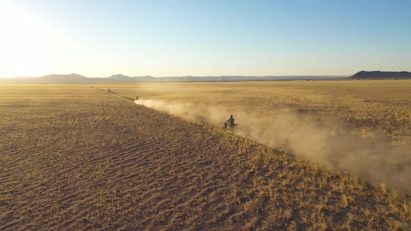 Aerial view of people riding quads off road in Namib desert, Namibia.
