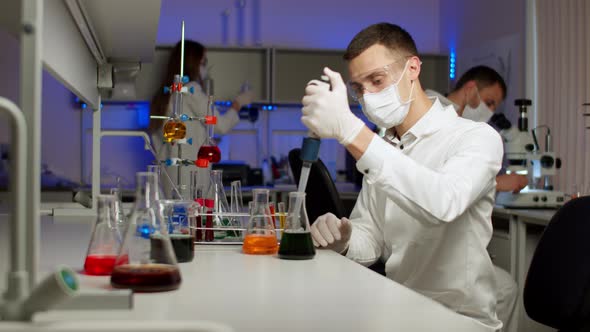 Young Scientist Mixing Colored Liquids