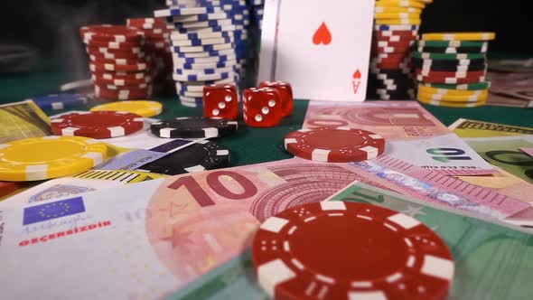 Gambling Red Dices Poker Cards And Money Chips In Smoke alt