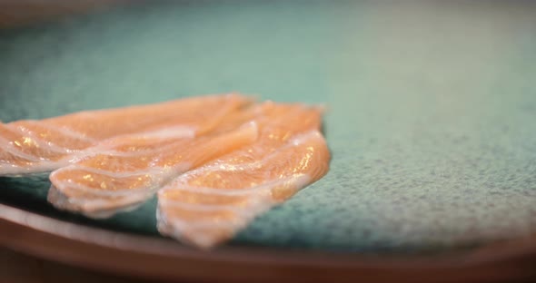 Three Pieces Of Salmon Sashimi On A Plate. - close up shot