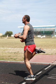 Fit Runner Sprinting On The Track