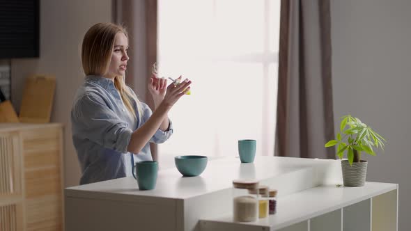 Attractive Girl Dancing in the Kitchen in the Early Morning