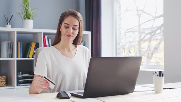 Young Woman Works at Home Office Using Computer.