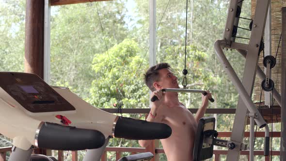 Strong Caucasian Man Doing Pull Up Exercise in a Gym in a Terrace at Home