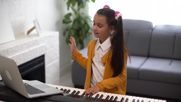 Little Girl Watching Online Lesson Tutorial How to Learn a Synthesizer