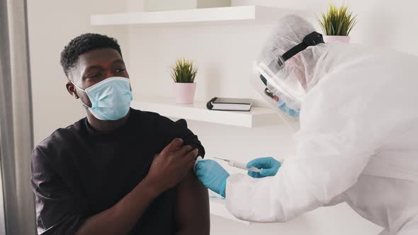 African American Black Man with Face Mask Receiving Vaccine Against Covid19