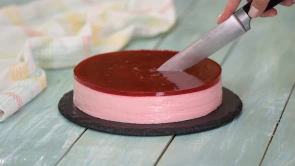 Close-up of Woman Cutting Fruit Mousse Cake.