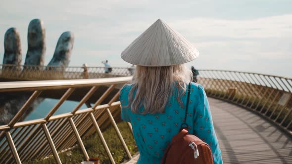 A girl walks with a Vietnamese hat on Ba Na Hills, Vietnam