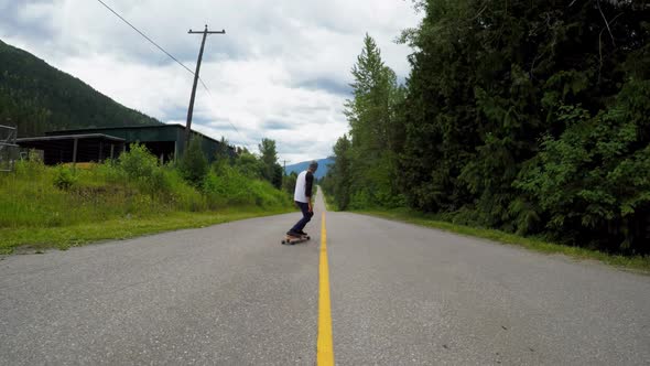 Man rides a skateboard on the road 