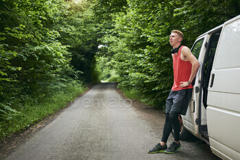 Runner leaning on van