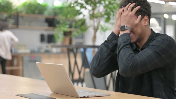 African American Man with Laptop Feeling Angry