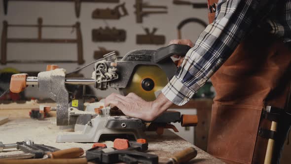 Carpenter Using an Electric Circular Saw Cutting Piece of Wood