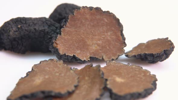 Black Truffle Fungus Slices on a White Surface