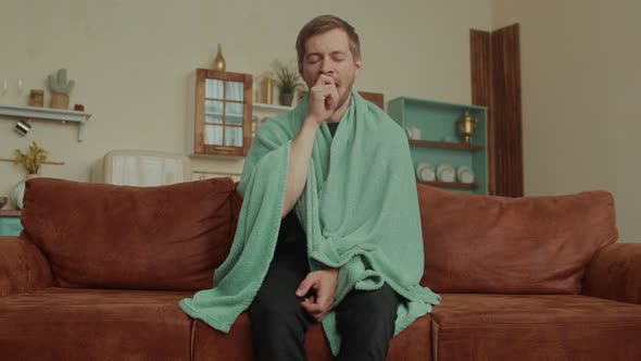 Tired Young Man Yawning in the Living Room