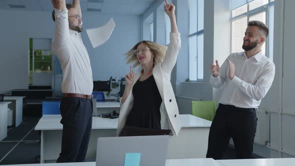 Delightful Teamwork of Young Lady and Two Men