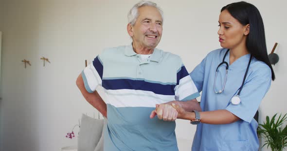 Animation of biracial female doctor and caucasian senior man during recovery