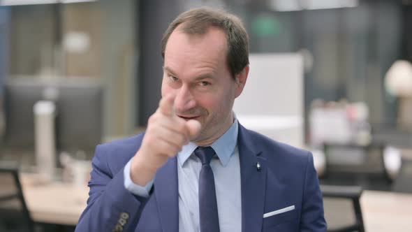 Portrait of Businessman Pointing at the Camera