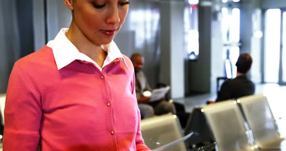 Woman holding air ticket and smiling